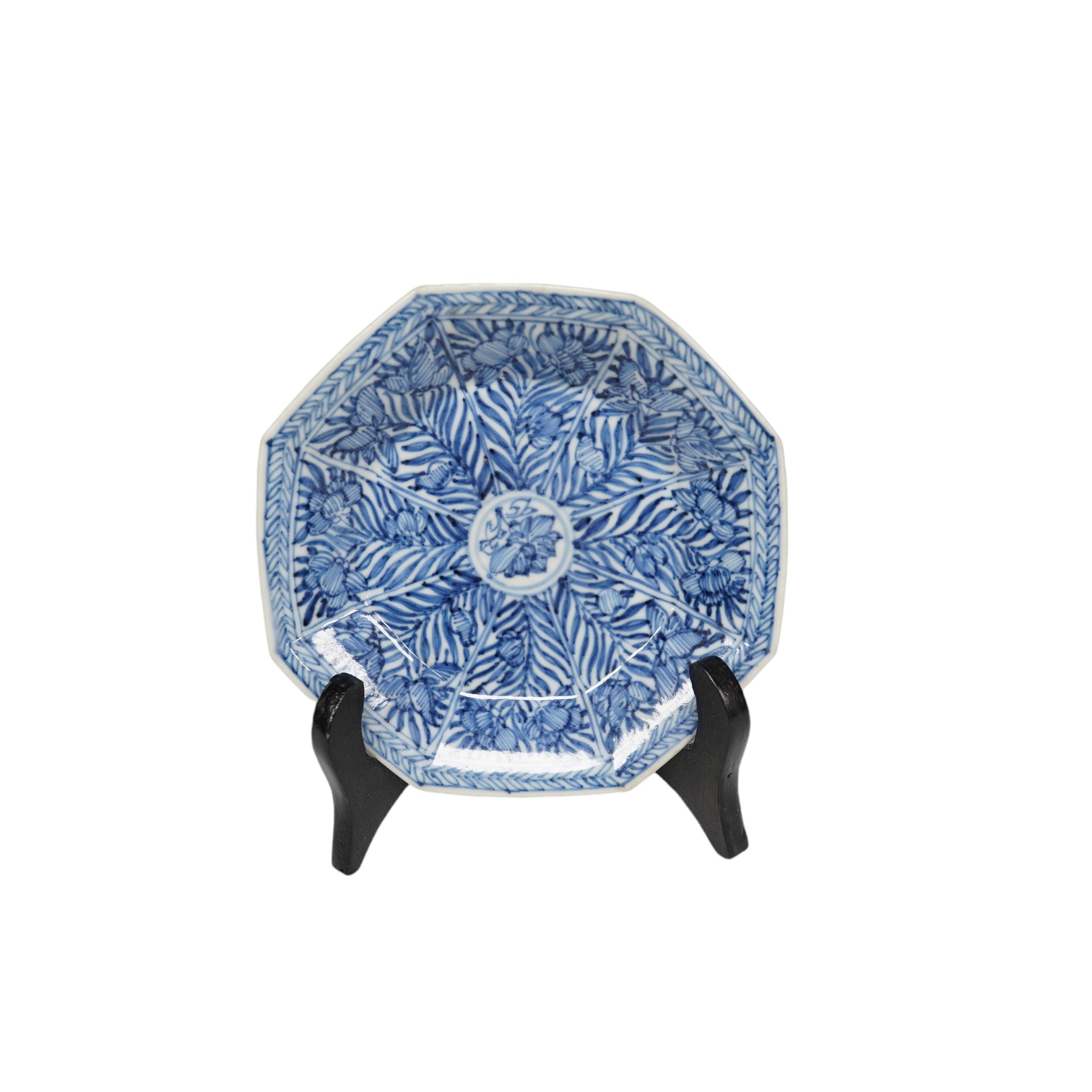 A Chinese blue and white octagonal saucer dish, Kangxi period, with stand, 9.5cm in diameter. Condition - good